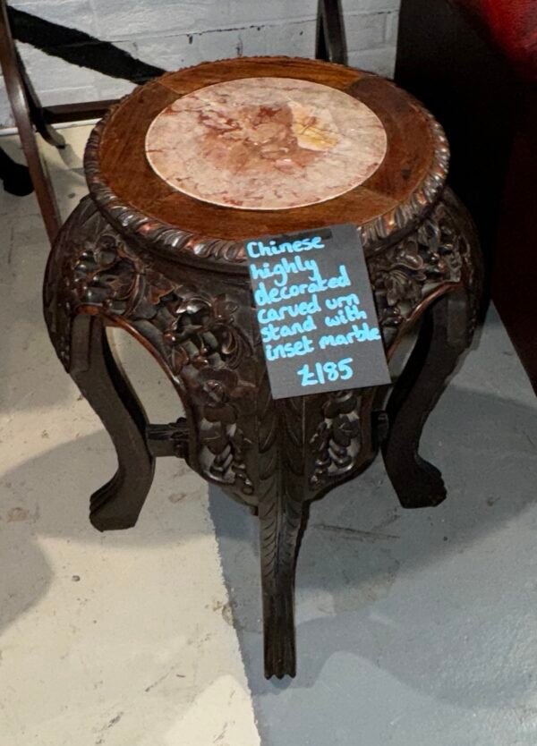 Chinese highly decorated carved urn stand with inset marble