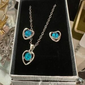 Boxed silver tone blue earrings and pendant