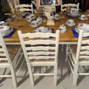 Solid pine farmhouse kitchen table with painted white turned legs and 6 white ladderback chairs with rush seats